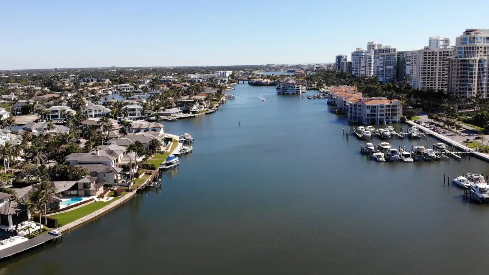 Aerial view of a Naples canal lined with waterfront homes and boats