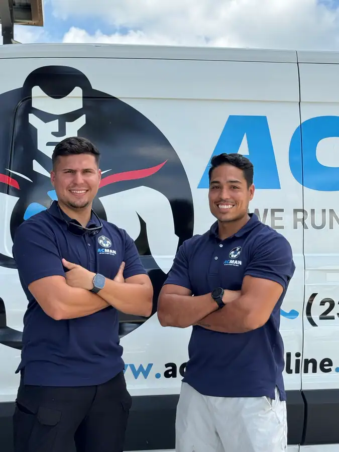 Two ACMAN technicians at the van