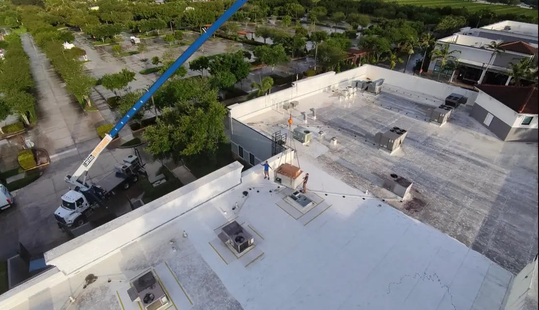 Aerial view of an ACMAN crane lift onto a commercial rooftop