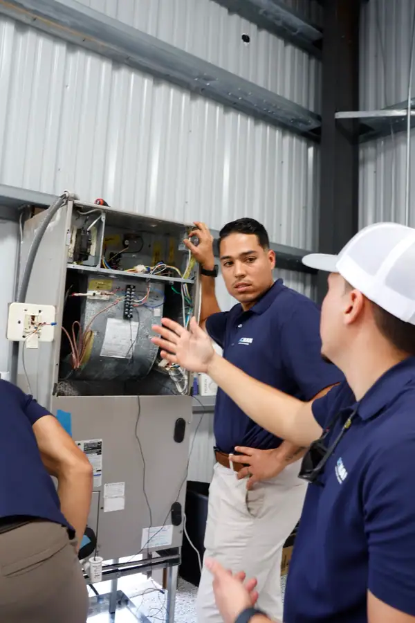 An ACMAN technician explaining a unit during training